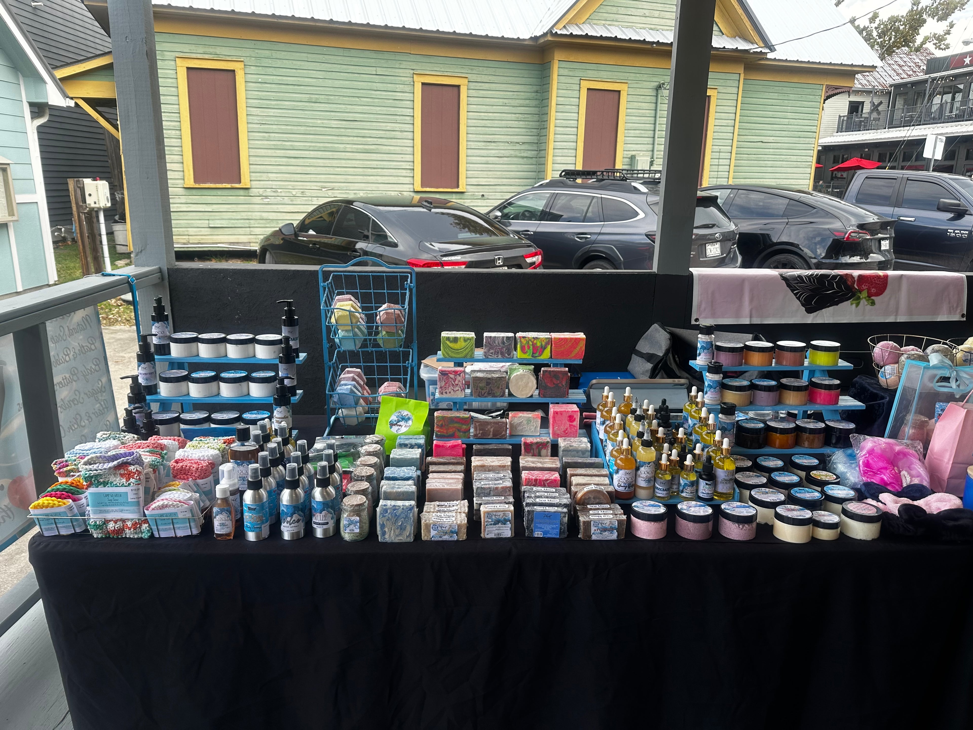 Table with various items on display in front of a building